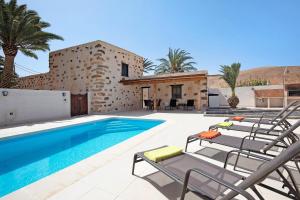 a villa with a swimming pool and a house at Casa Rural Andresito in Pájara