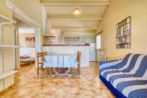 a living room with a table and a kitchen at Gite Gariotte in Salignac Eyvigues