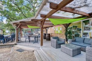 a wooden deck with chairs and a table at Gite Gariotte in Salignac Eyvigues