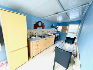 a small kitchen with a sink and a refrigerator at Siera Home in Berat