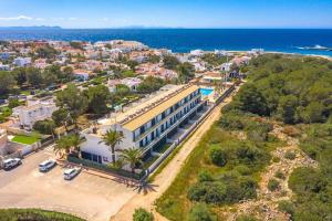 an aerial view of a building and the ocean at Sa Perdiu 14 Menorca in Cala Santandria