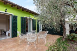 a patio with a table and chairs in front of a house at Agriturismo Green House in Santo Stefano al Mare