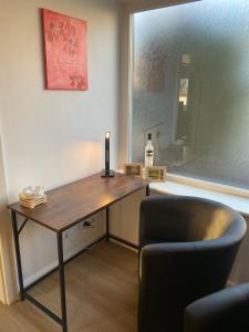 a desk in a room with a chair and a window at Villa Klitzeklein in Bad Belzig
