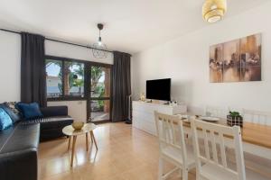 a living room with a couch and a table at Coral Bliss-Oasis Duna in Corralejo