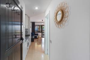 a hallway leading to a living room with a mirror at Coral Bliss-Oasis Duna in Corralejo