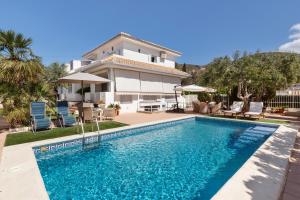 a swimming pool in front of a house at Semisótano in Cartagena