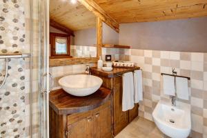 a bathroom with a sink and a toilet and a shower at Chalet Del Cuore in Valdisotto +18 photos