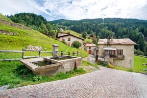 a water fountain in a field next to a house at Chalet Del Cuore in Valdisotto