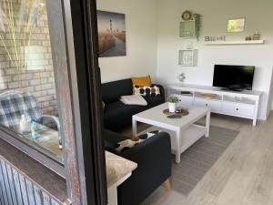 a living room with a couch and a table at Ferienwohnung Halvar in Maasholm