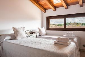 a bedroom with a large bed with towels on it at La Chirumba in Aldeatejada +20 photos