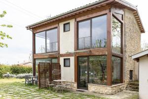 a house with large glass windows and a patio at Masseria del Ponte in Pretoro