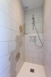 a bathroom with a shower with white tiles at Gîte Le Chalimont in Saint-Julien-en-Vercors +13 photos