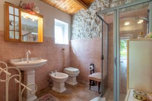 a bathroom with a toilet and a sink and a shower at Casa Il Carrubbo in Modica +16 photos