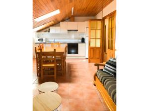 a kitchen and dining room with a table and chairs at Peña Yerga in Hospital