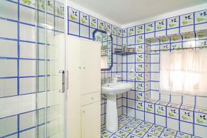 a bathroom with blue tiled walls and a sink at Casa Florio in Taormina +14 photos