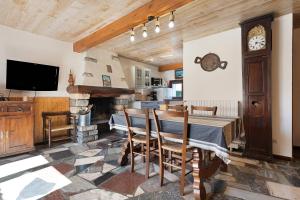 a dining room with a table and a fireplace at Gîte de La Séoube in Campan