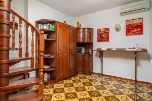 a room with a staircase and a book shelf at Casa Florio in Taormina