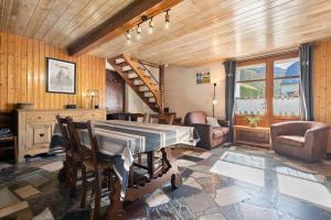a room with a table and chairs and a staircase at Gîte de La Séoube in Campan