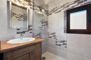 a bathroom with a sink and a shower at Gîte de La Séoube in Campan +28 photos