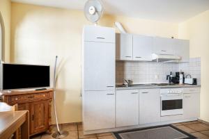a kitchen with a white refrigerator and a tv at Ferienwohnung 2 in Bernkastel-Kues