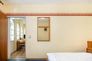 a bedroom with a mirror on the wall at Ferienwohnung 2 in Bernkastel-Kues