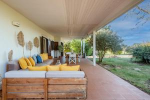 a living room with a couch on a patio at House in Villa Torto in Monopoli