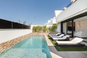 a swimming pool in the backyard of a house at Chalet con Piscina en San Javier in San Javier