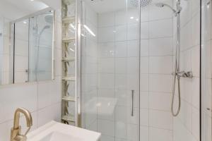 a white bathroom with a shower and a sink at El Doctoral in Vecindario +19 photos
