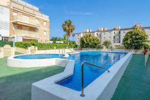 a swimming pool in the middle of a building at Atico Duplex Pepe y Rosi in Cunit