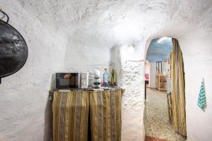 a room with a table with a microwave on it at Cueva in Almería