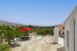 a red umbrella sitting on the side of a building at Cueva in Almería