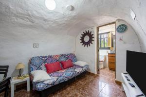 a living room with a couch and a tv at Cueva in Almería
