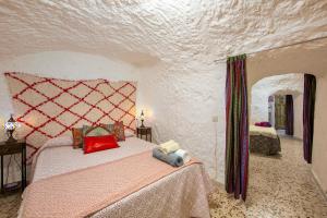 a bedroom with a bed with a teddy bear on it at Cueva in Almería