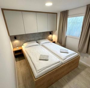 a bedroom with a large bed with a large headboard at Mobile Home Ella in Murter