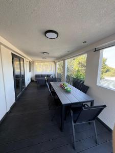 a dining room with a wooden table and chairs at Mobile Home Ella in Murter