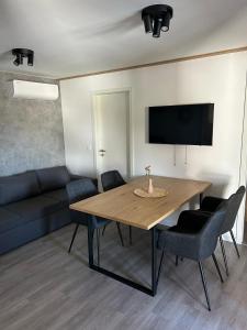 a dining room with a table and a couch at Mobile Home Ella in Murter