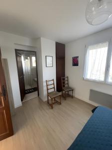 a bedroom with two chairs and a bed and a window at Gite Le Paradis in Pern +11 photos