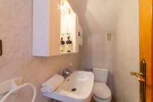 a small bathroom with a sink and a toilet at Casa Rural La Buganvilla in Níjar +26 photos