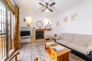 a living room with a couch and a fireplace at Casa Rural La Buganvilla in Níjar