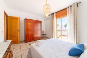 a bedroom with a bed and a large window at Casa Rural La Buganvilla in Níjar