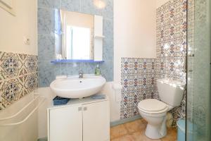 a bathroom with a sink and a toilet at Chambres D'hôtes in Saint-Cyprien
