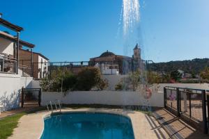 a swimming pool in the backyard of a house with a fountain at El Balcón de la Sierra in Seville