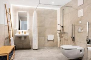 a bathroom with a shower and a toilet and a sink at Ferienwohnung Götz in Roßhaupten +13 photos