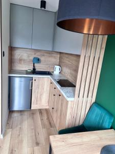 a small kitchen with a sink and a counter at elli apartament Sieradz in Sieradz