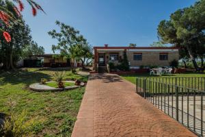 a brick walkway in front of a house at Villa Manolita in Carmona