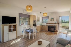 a living room with a table and a fireplace at Villa Manolita in Carmona