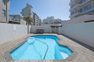 a swimming pool on the roof of a building at Nautica by the Sea in Cape Town