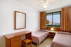 a hotel room with two beds and a mirror at Casa Puerto Rico in Mogán +11 photos