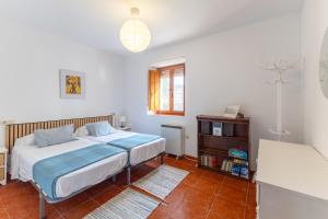a bedroom with a bed and a dresser in it at De los Maestros in El Arenal
