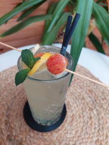 a drink with a peach and fruit on a table at Garni Unterweggütl in Naturno